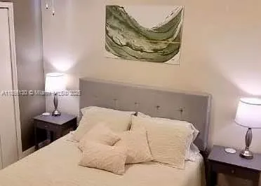a bedroom with a bed and a lamp