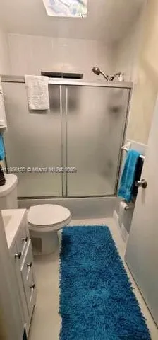a bathroom with a toilet and a shower