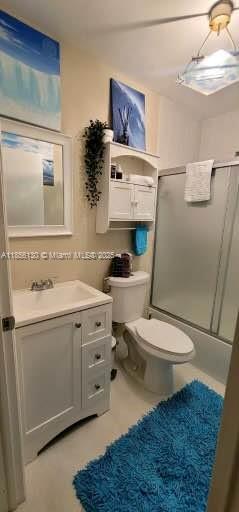 14447 Southwest 152nd Terrace, Unit BACKDOOR Miami, FL 33177 - Photo 7 of 10 a bathroom with a granite countertop toilet sink and mirror