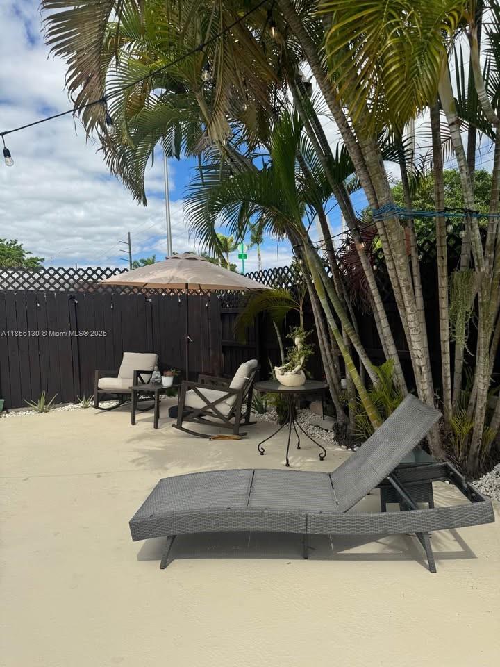 14447 Southwest 152nd Terrace, Unit BACKDOOR Miami, FL 33177 - Photo 10 of 10 a view of swimming pool with outdoor seating and trees in the background