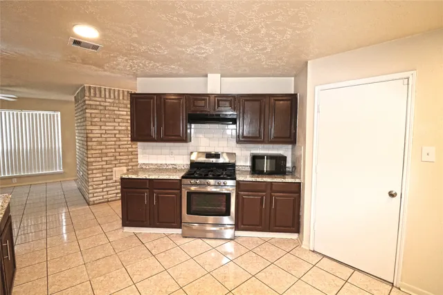 a kitchen with cabinets and steel stainless steel appliances