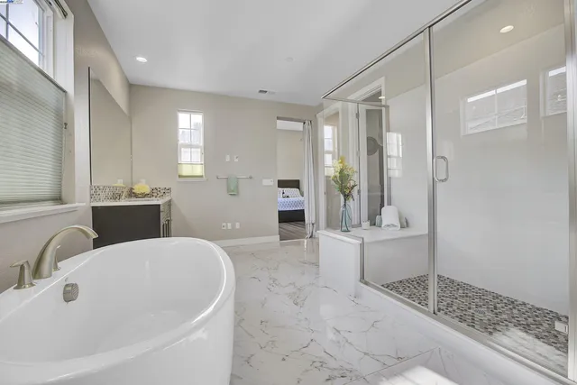 a large bathroom with a tub and shower