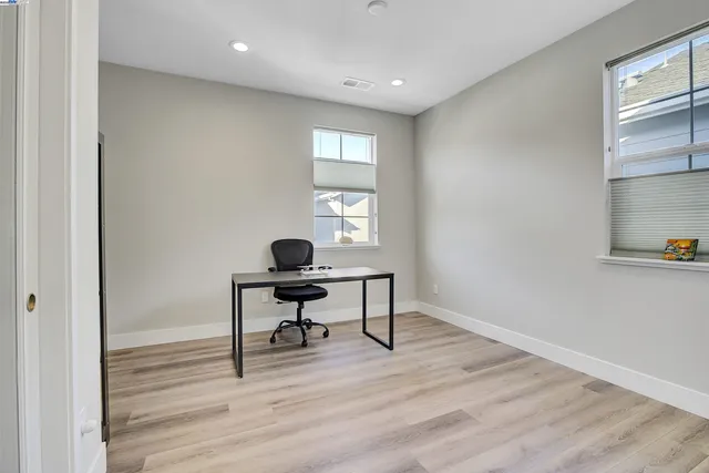 a workspace with wooden floor and a window