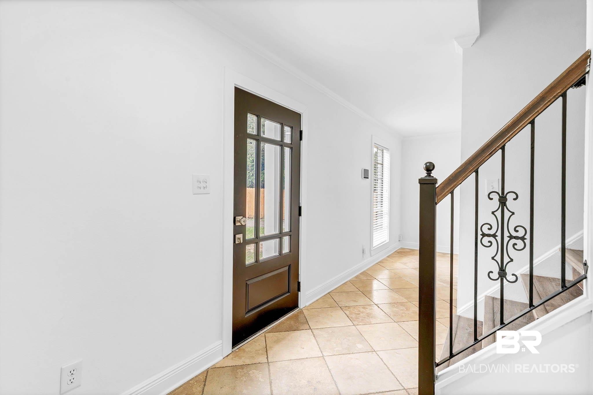 4705 Sherry Court Mobile, AL 36693 - Photo 9 of 100 Entryway with light tile patterned flooring, crown molding, and stairs