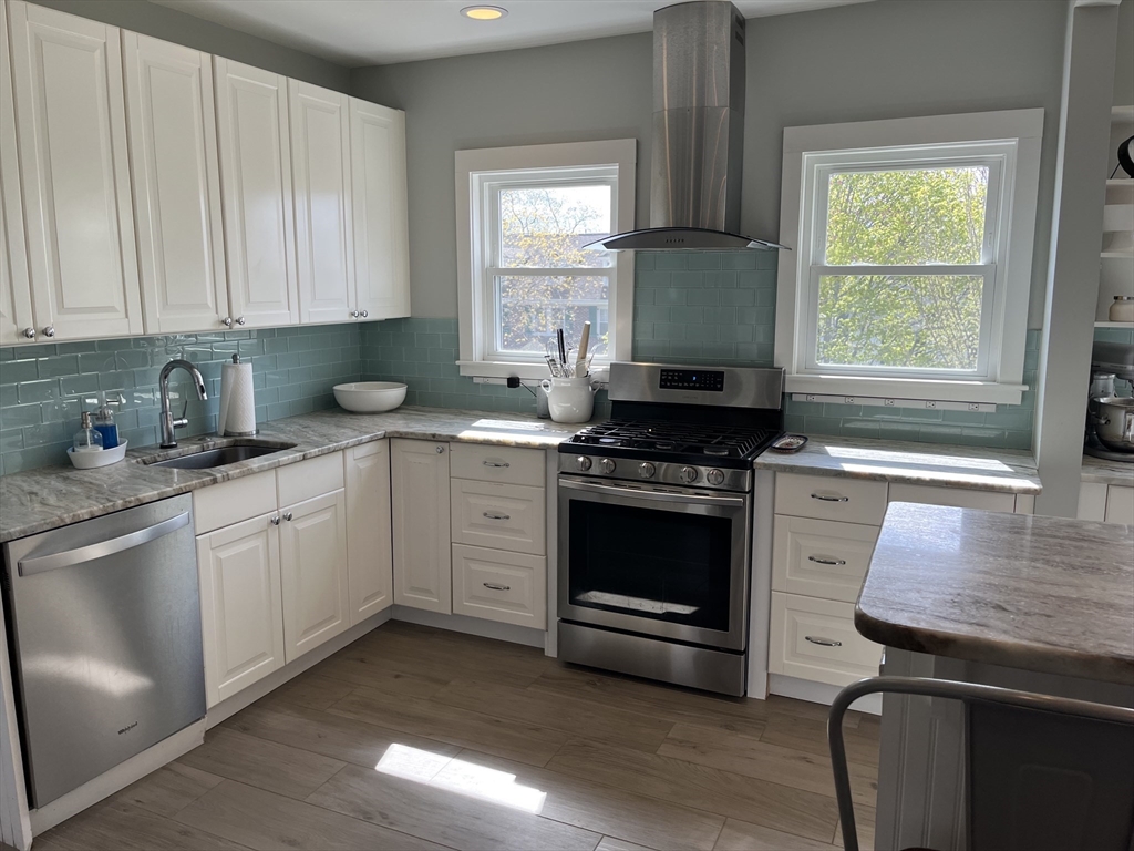 3 Chester Road, Unit 3 Belmont, MA 02478 - Photo 5 of 40 a kitchen with stainless steel appliances a stove sink and cabinets