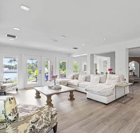 a view of a dining room with furniture a chandelier and wooden floor