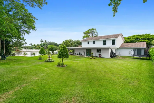 a front view of a house with a garden and a yard
