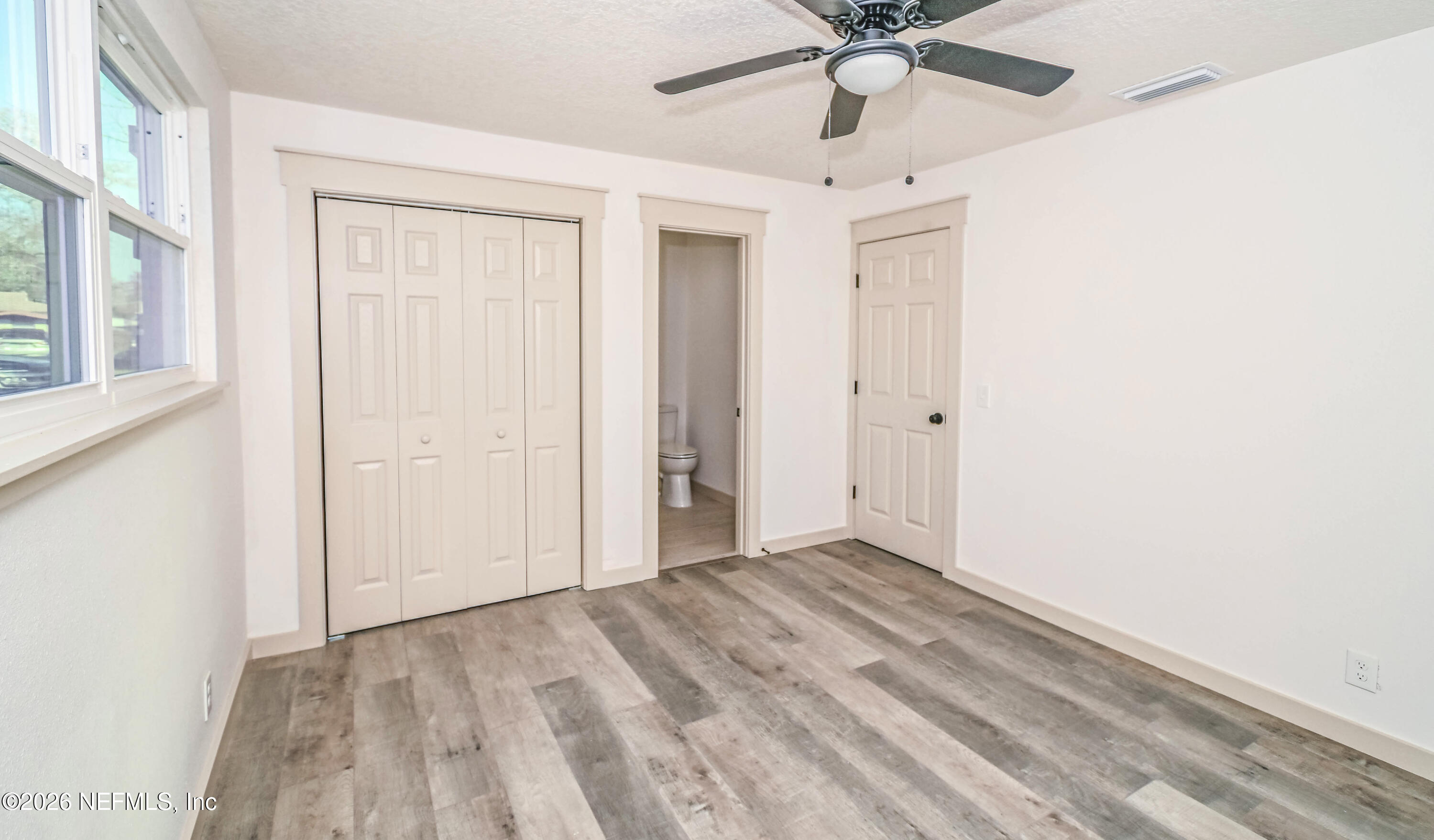 406 Barbara Circle Macclenny, FL 32063 - Photo 21 of 31 an empty room with a ceiling fan and a window