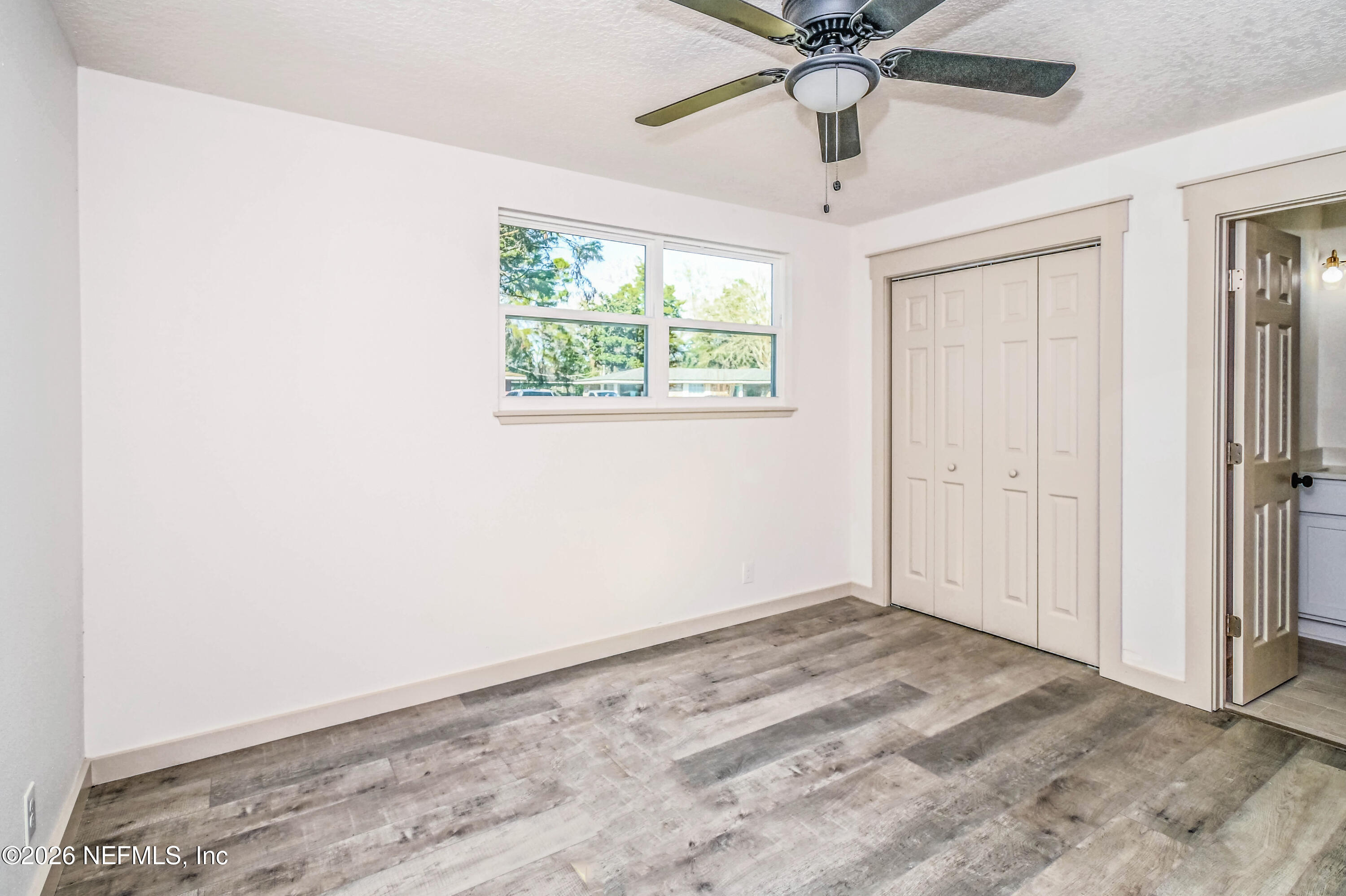 406 Barbara Circle Macclenny, FL 32063 - Photo 22 of 31 wooden floor in an empty room with a window