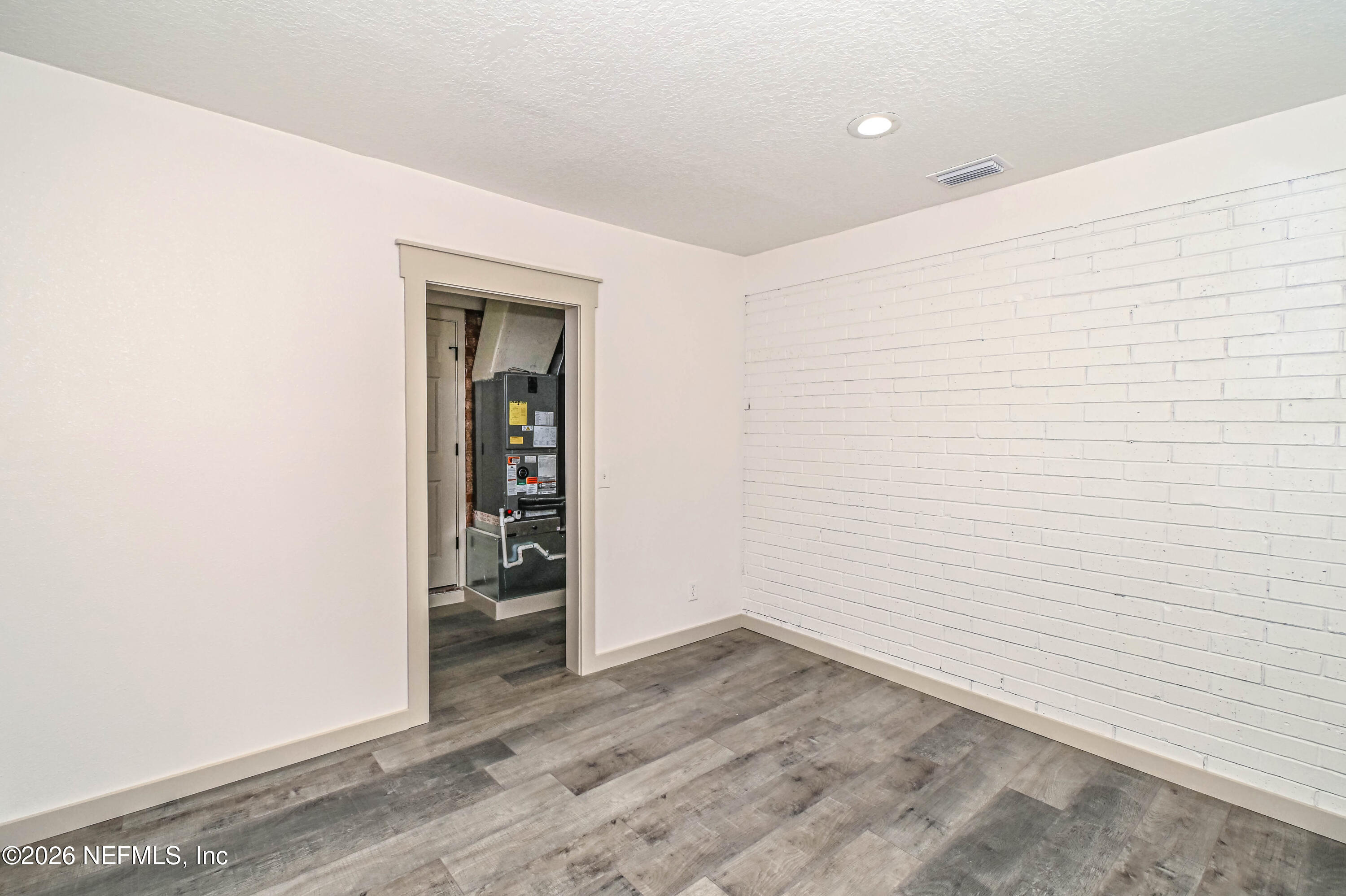 406 Barbara Circle Macclenny, FL 32063 - Photo 26 of 31 an empty room with wooden floor and closet