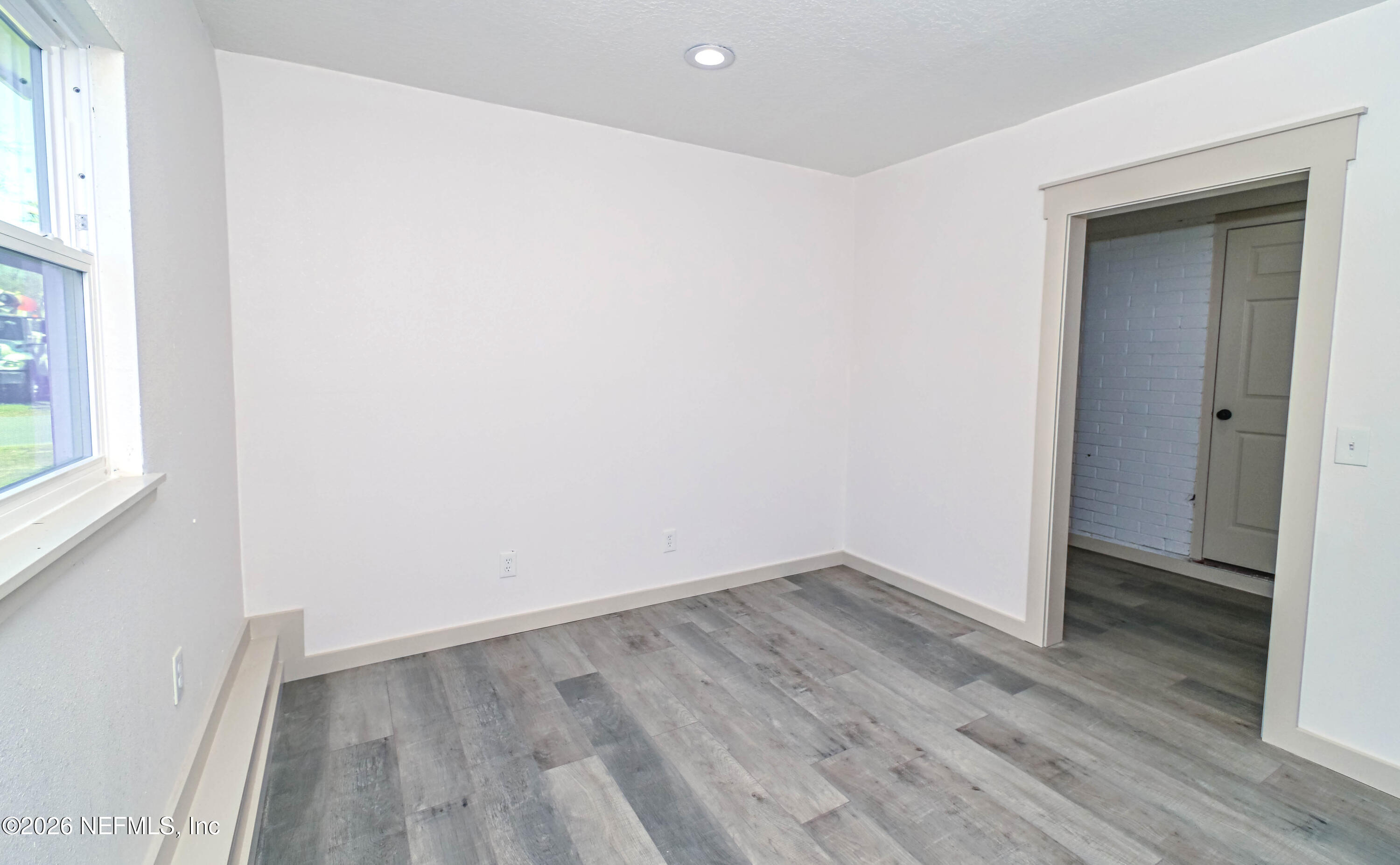 406 Barbara Circle Macclenny, FL 32063 - Photo 27 of 31 an empty room with wooden floor and windows