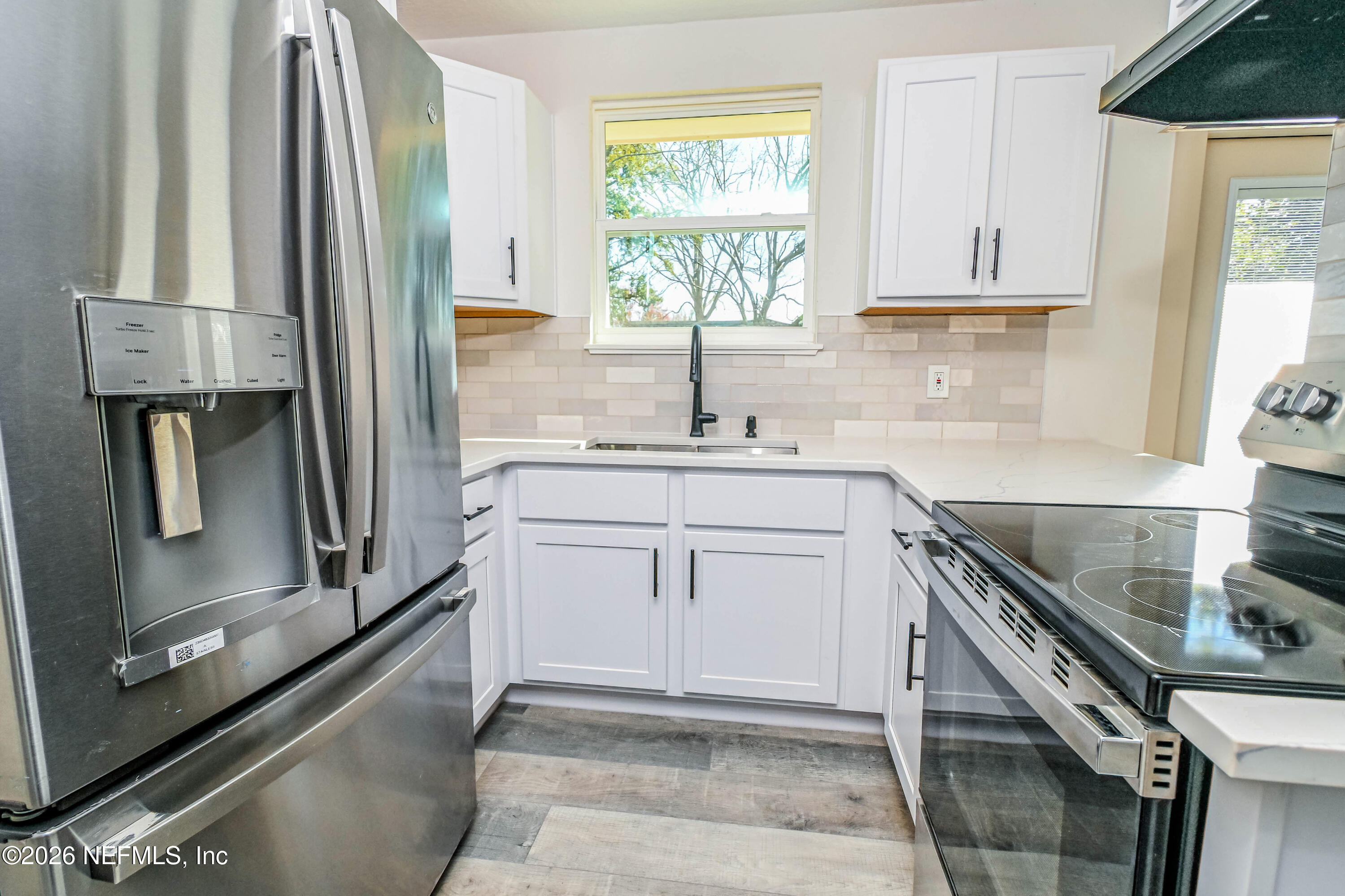 406 Barbara Circle Macclenny, FL 32063 - Photo 4 of 31 a kitchen with a sink stove and cabinets