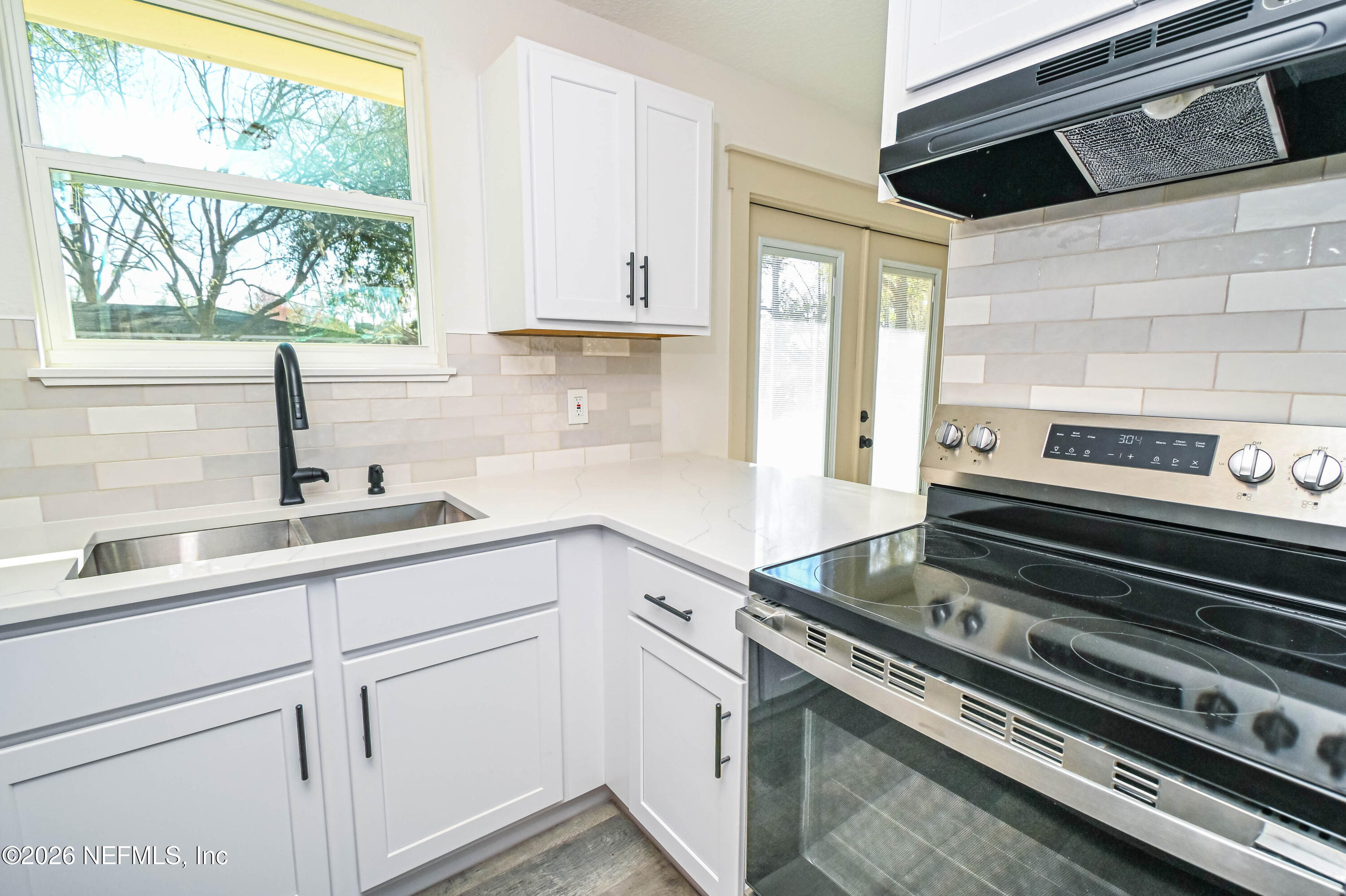 406 Barbara Circle Macclenny, FL 32063 - Photo 7 of 31 a kitchen with a stove and a sink