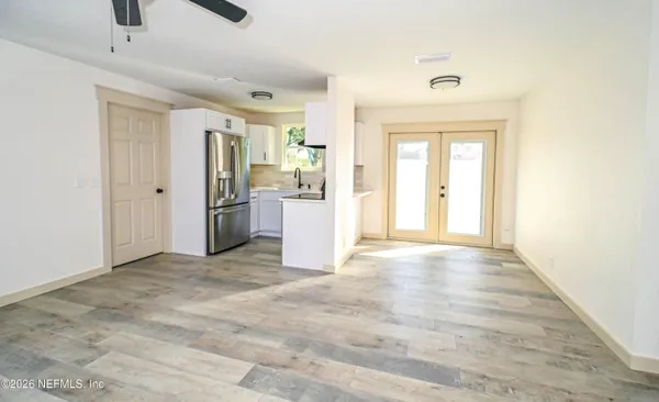 a view of a kitchen with a refrigerator and a sink