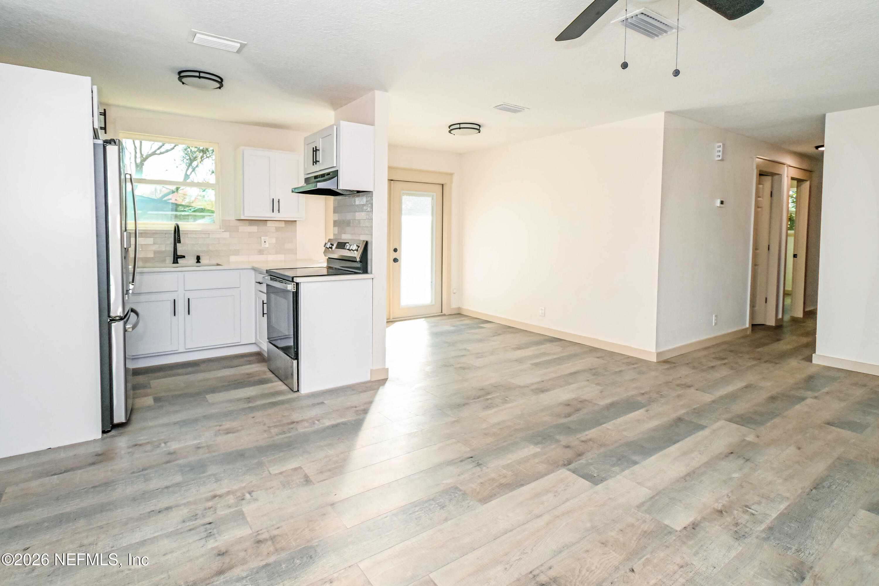 406 Barbara Circle Macclenny, FL 32063 - Photo 9 of 31 a kitchen with a refrigerator and a sink