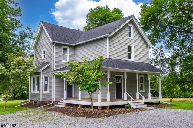 a front view of a house with a garden and plants