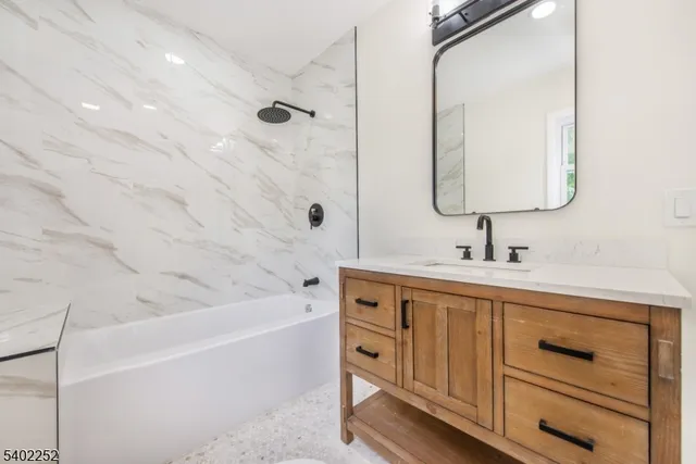 a bathroom with a bathtub and a sink