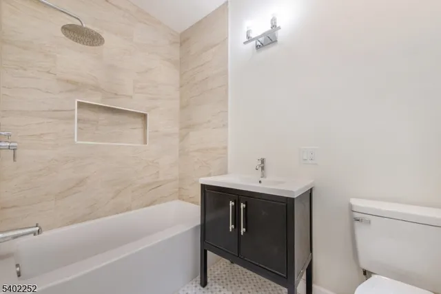 a bathroom with a sink a toilet and bathtub