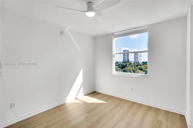 an empty room with windows and entrance