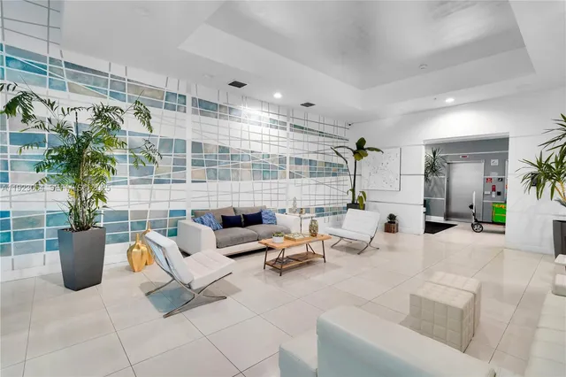 a living room with furniture and a potted plant