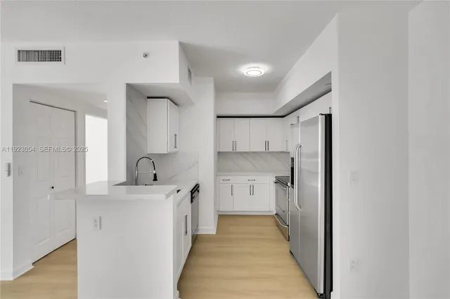 a kitchen with a sink and cabinets