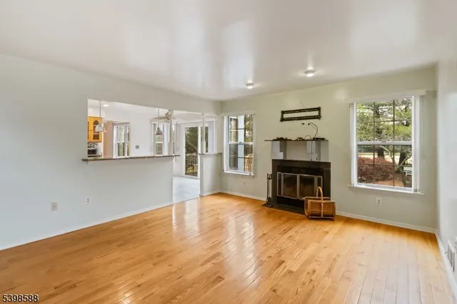 a view of a livingroom with a fireplace and window