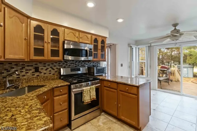a kitchen with stainless steel appliances granite countertop a stove and a sink