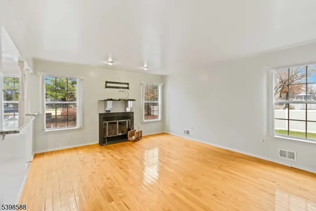 a big room with windows and fireplace