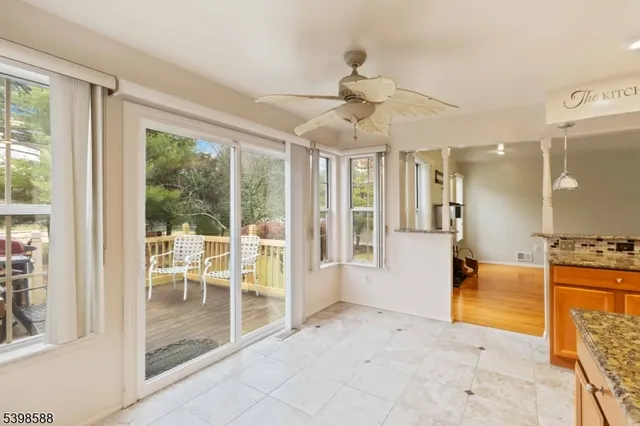 a view of a big room with windows chandelier and front door