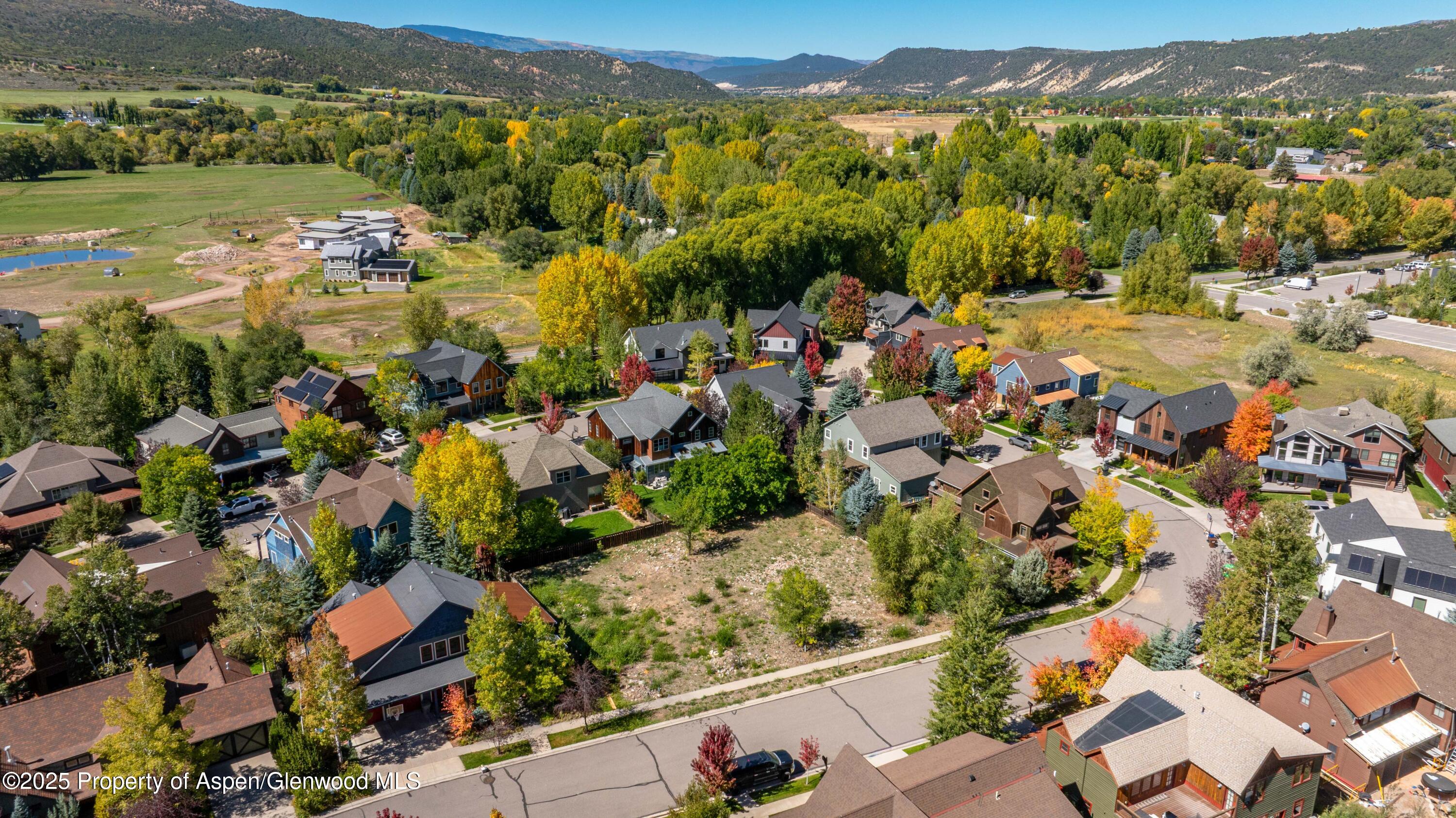 an aerial view of residential houses with outdoor space
