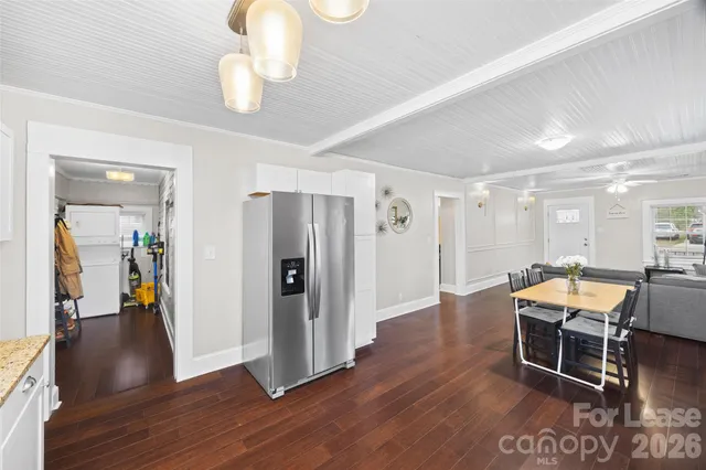 a view of a room with wooden floor lounge chair and windows