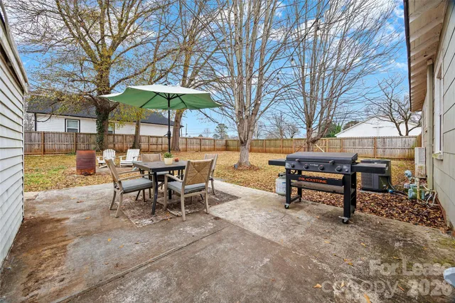 a view of a tables and chairs under an umbrella