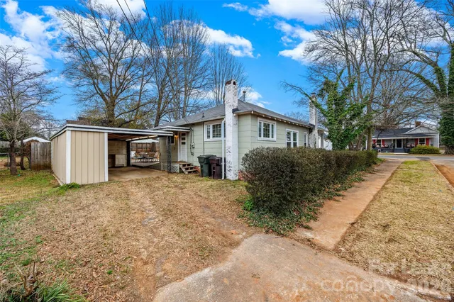 a view of a house with a yard covered in snow