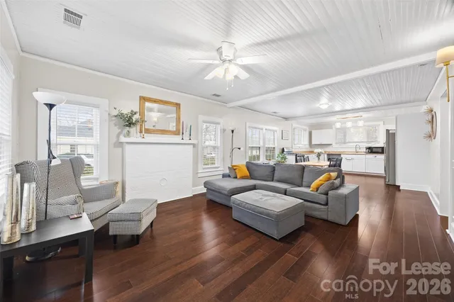 a living room with furniture or wooden floor and a chandelier
