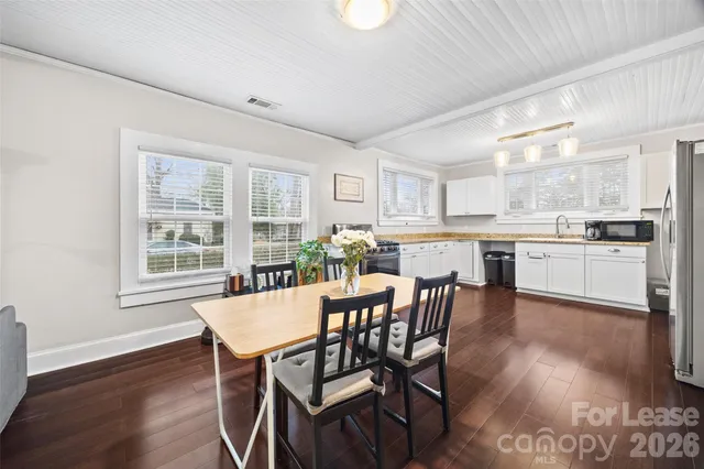 a dining room with furniture and wooden floor