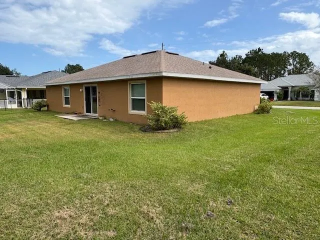 an aerial view of a house with garden space and street view