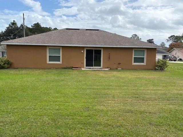 an aerial view of a house with garden space and street view