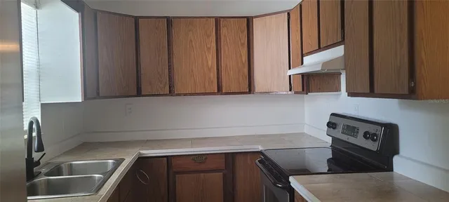 a kitchen with a sink and cabinets