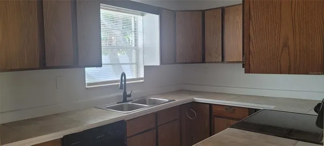 a kitchen with a sink and cabinets