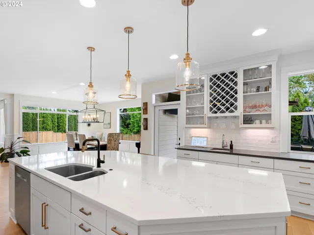 a kitchen with sink refrigerator and window