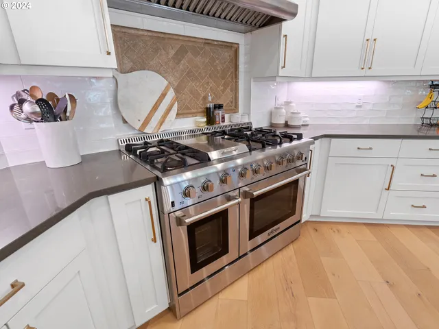 a stove top oven sitting inside of a kitchen