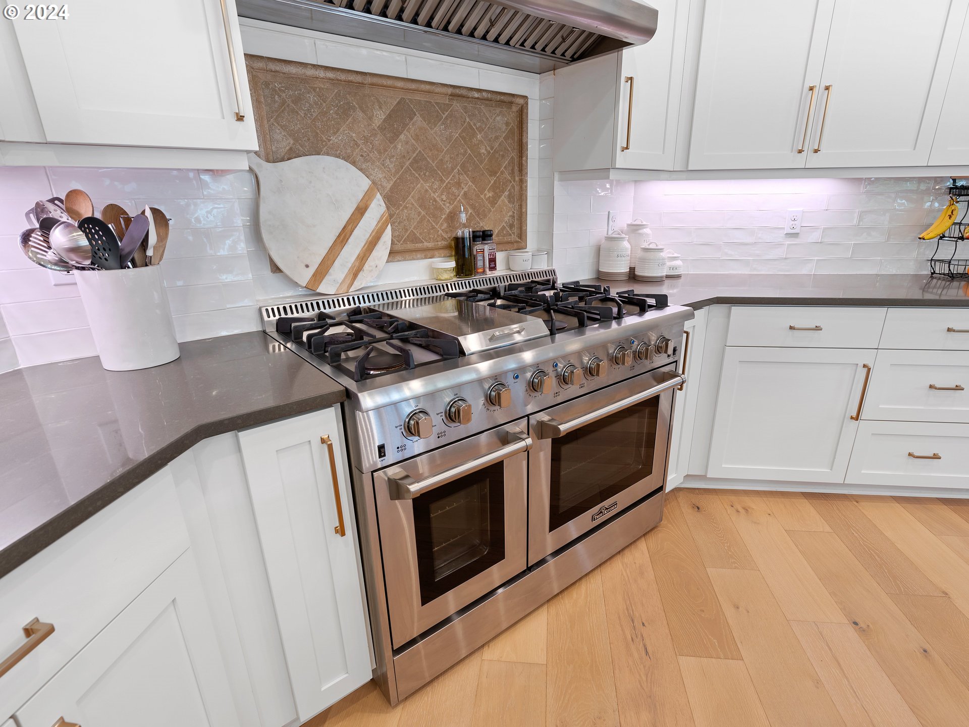 9010 Southwest Inez Street Tigard, OR 97224 - Photo 18 of 42 a stove top oven sitting inside of a kitchen