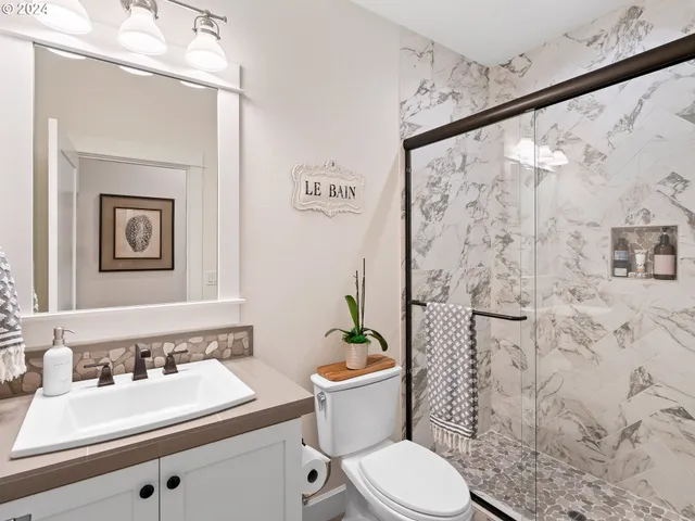 a bathroom with a sink a toilet and shower curtain