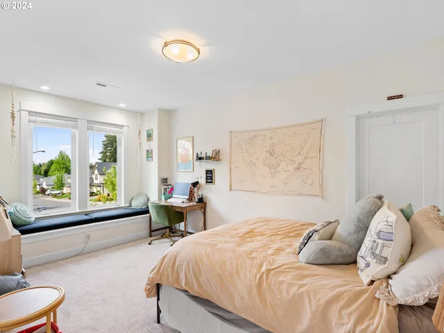 a bedroom with a bed and a large window