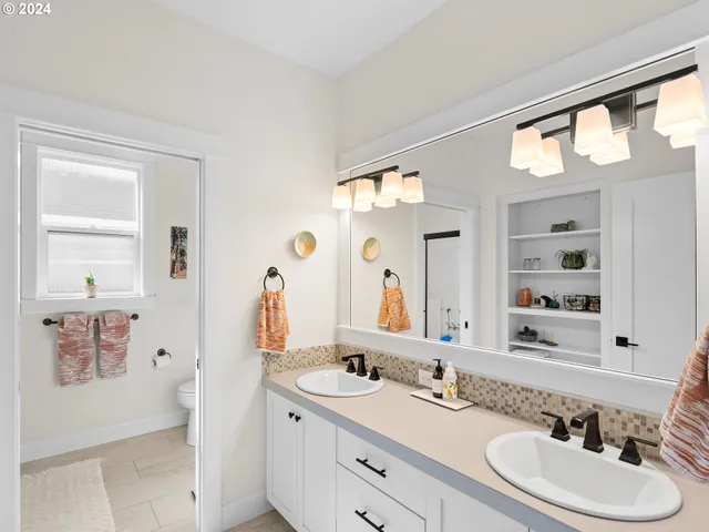 a bathroom with a double vanity sink and a mirror
