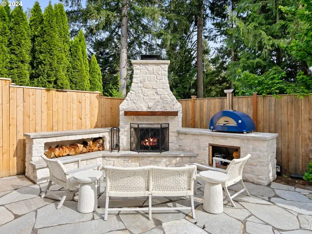a white bench sitting in front of a fireplace