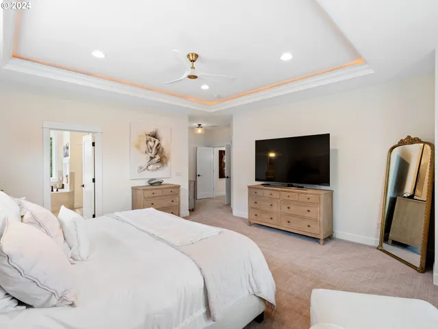 a bedroom with a bed and a flat tv screen on wall