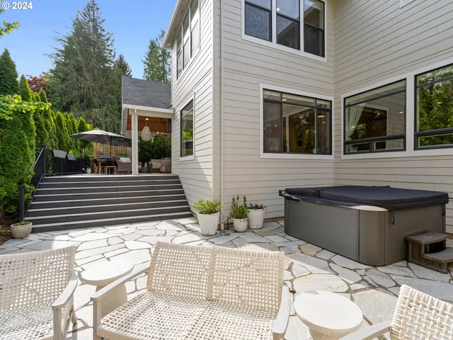 a view of a patio with couches table and chairs and potted plants
