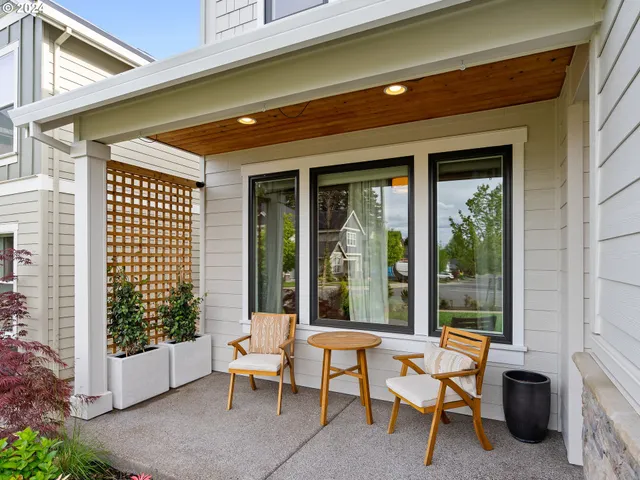 a balcony with furniture and large windows