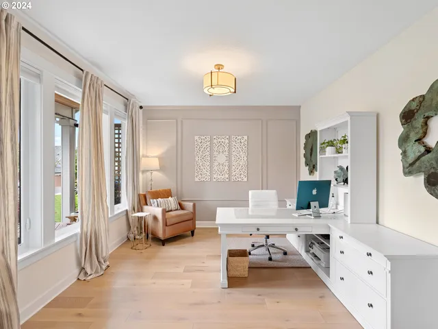 a bedroom with furniture and a large window